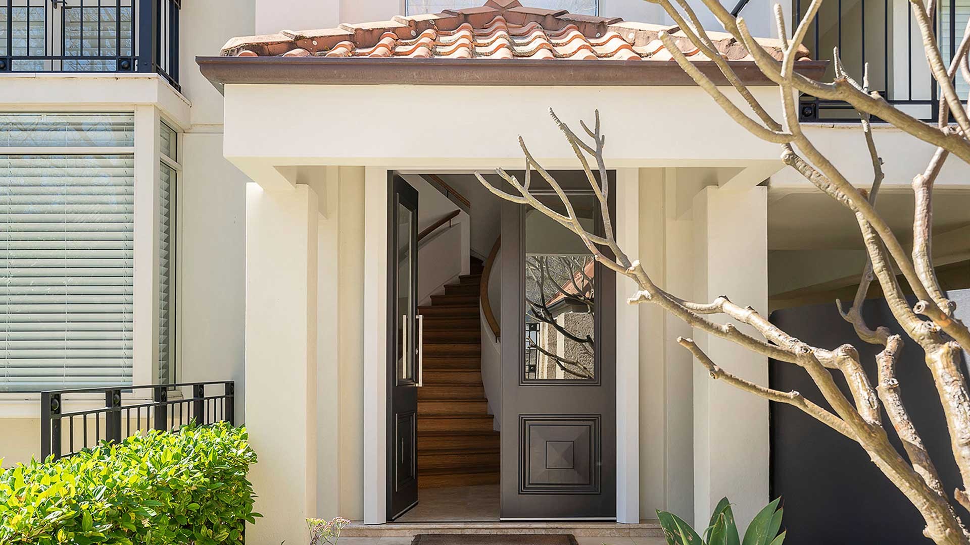 Classic white Perth home entry with a timber staircase